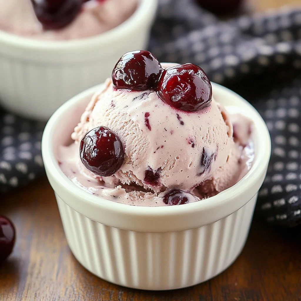 Delicious cherry chocolate dessert topped with fresh cherries and chocolate shavings.