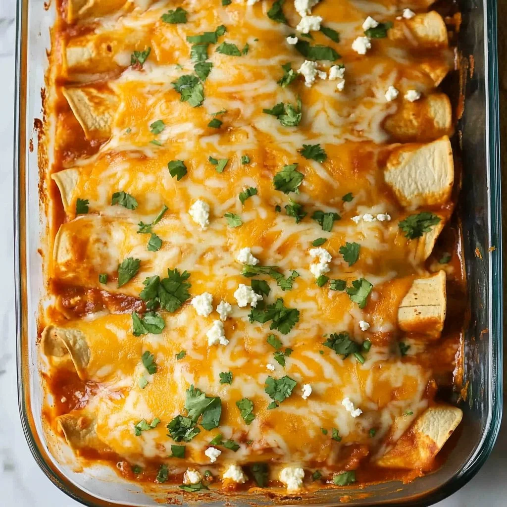 Creamy chicken enchiladas topped with cheese and fresh cilantro
