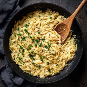 Creamy Garlic Parmesan Orzo served in a bowl with fresh herbs