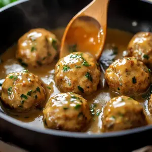 Plate of easy chicken meatballs served with marinara sauce and herbs