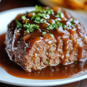 Delicious sticky glazed meatloaf served on a rustic wooden plate